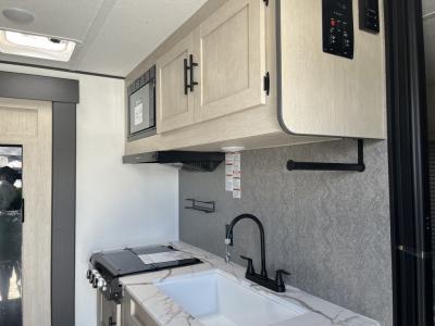 Overhead microwave and kitchen storage area