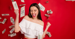 happy woman with money falling around her
