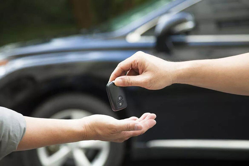 People exchanging car keys