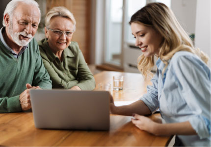 Couple looking at a computer screen with saleswoman