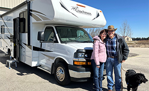 family of four smiling in their RV