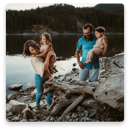 family playing by a river