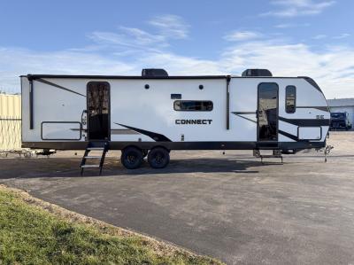 Curbside view showing dual entry doors and slide-out