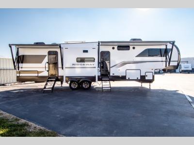 Full curbside shot with large slideouts and awning open