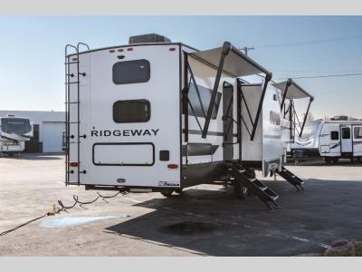Rear roadside view with entry stairs and utility connections