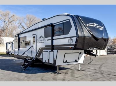 Front angle of the 2025 EAST TO WEST Blackthorn Half-Ton 27BH-OK showing aerodynamic fiberglass cap and LED accents.
