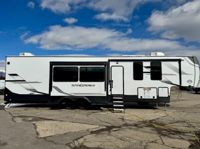 Passenger-side profile showing three slideouts and main entry