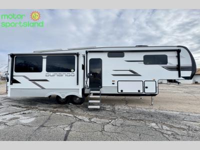 Passenger side of Durango D301RLT fifth wheel featuring extended dual awnings, large slide-out, and outdoor speakers.