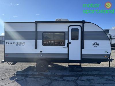 Passenger side view showing entry door, awning, and dual axles