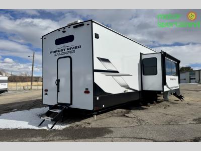 Rear curbside view of trailer with awning retracted