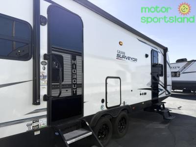Passenger side view of Surveyor travel trailer with door