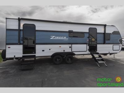 Rear corner angle highlighting tandem axles and aluminum siding
