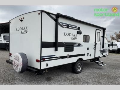 Rear curbside angle with spare tire cover and exterior storage