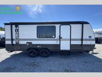 Full curbside profile of the trailer with dual axles and central entry door