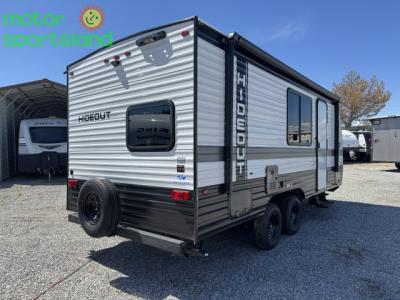 Rear curbside corner showing vertical taillights and spare tire
