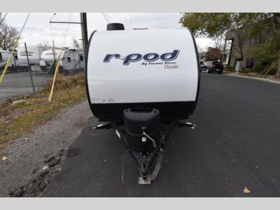 Head-on front view of the R Pod RP-107C with diamond plate rock guard and dual propane tanks.