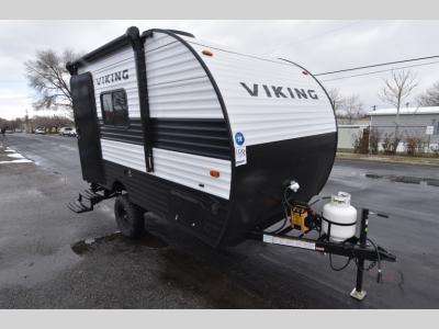 Front passenger side of 2024 Viking Saga 14SR travel trailer with propane tank and manual tongue jack