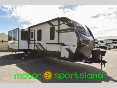 Passenger front angle view of 2024 Winnebago Voyage V3235RL travel trailer