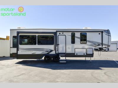 Passenger side of Sandpiper 3370RLS with slideout extended