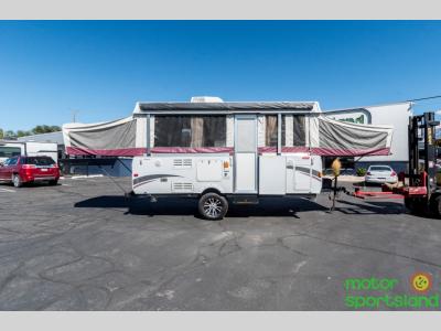 Full curbside view with tent beds and slideout expanded