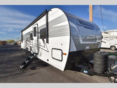 Front angle of 2024 Winnebago Access 30BH travel trailer with sharp black accents and dual propane setup