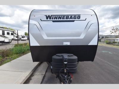 Head-on view showing Winnebago badge, propane tanks, and aerodynamic profile