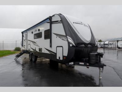 Front corner view of 2025 Alta 2600KRB travel trailer with dual propane tanks