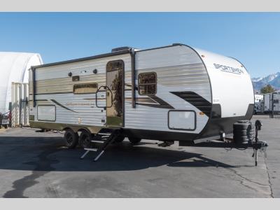 Passenger side view of 2025 KZ Sportsmen SE 241BHKSE trailer parked outdoors