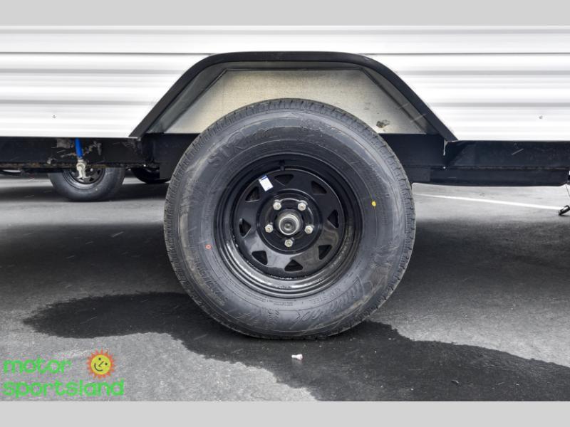 Close-up of wheel and fender flare on single axle trailer