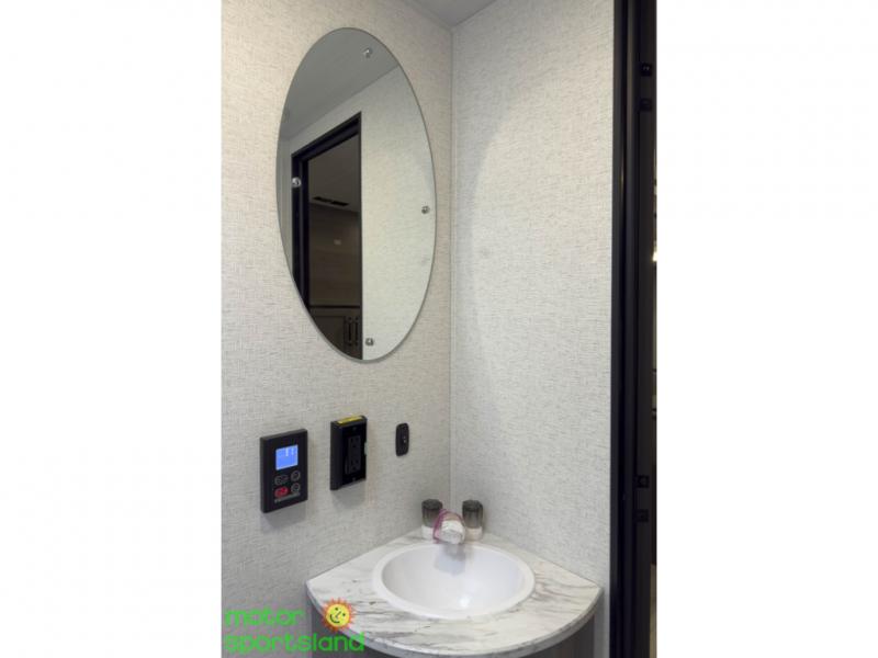 Bathroom vanity with sink, mirror, and wall outlets