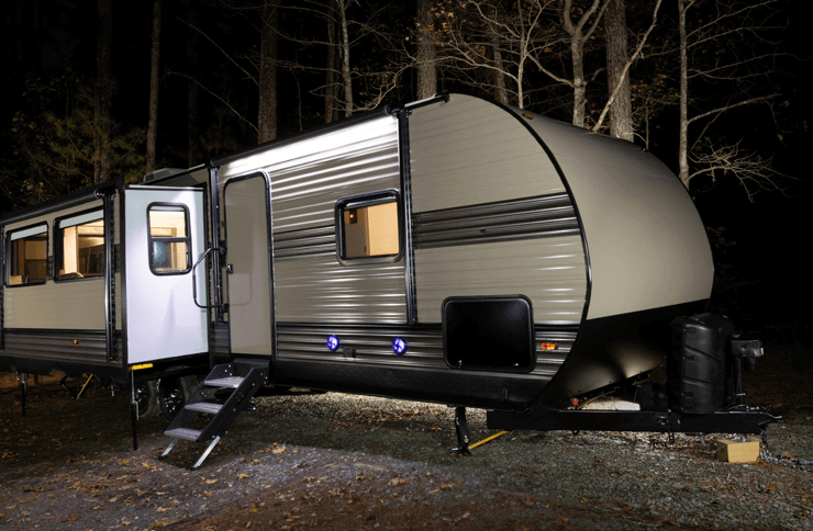 travel trailer at night in the woods