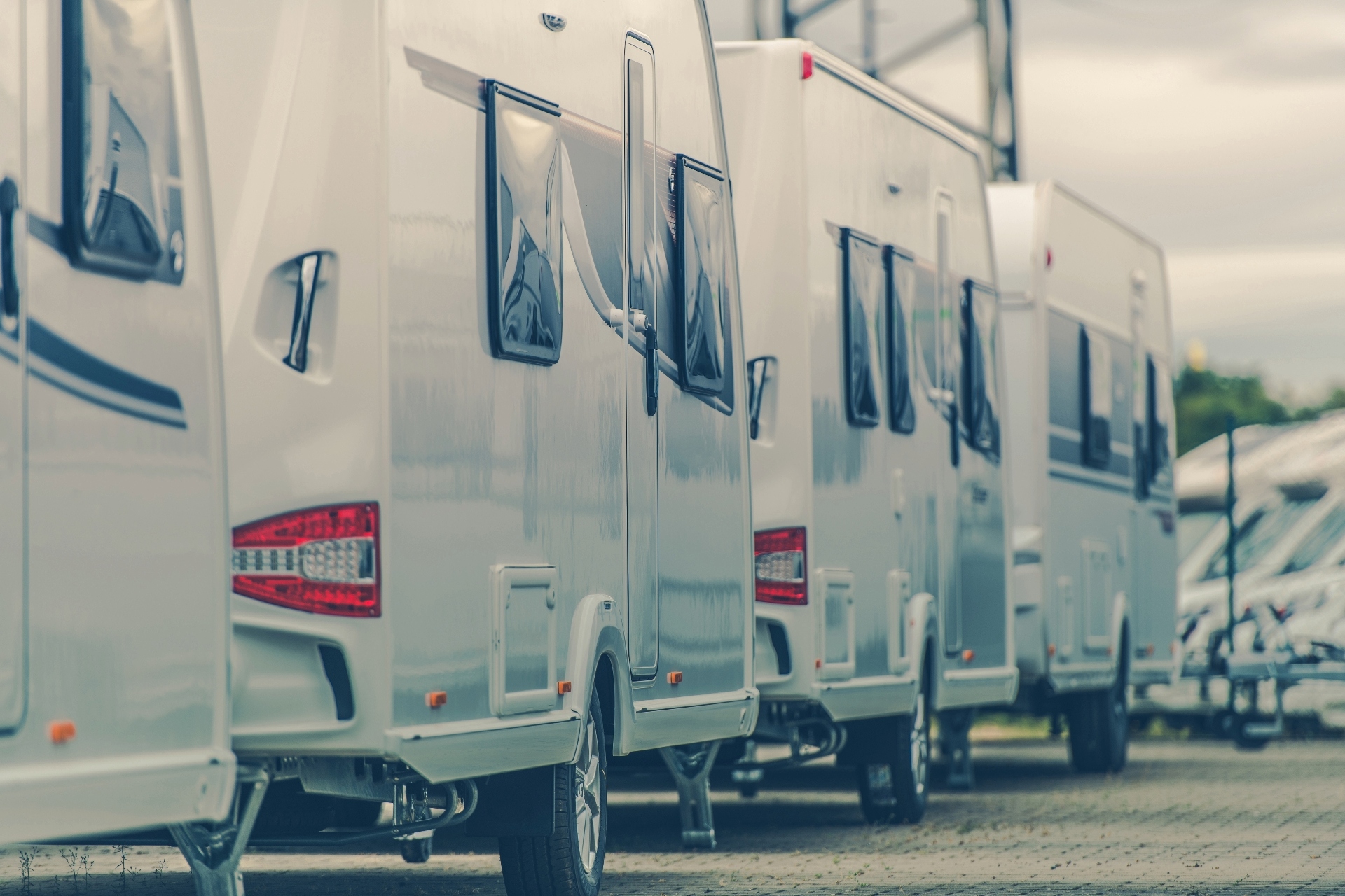 A line of RVs at a dealership