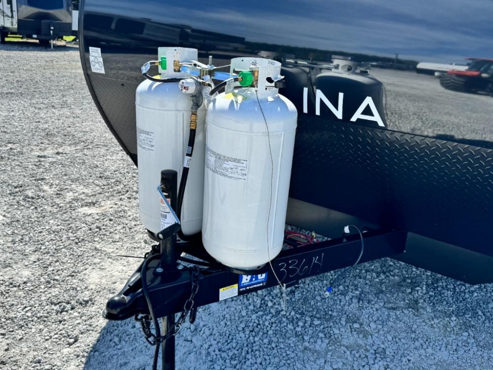 Front profile of 2025 Coachmen Catalina 261BH travel trailer featuring diamond plate rock guard and power tongue jack.