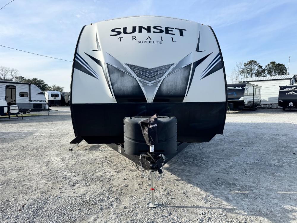Used 2020 CrossRoads Sunset Trail SS289QB travel trailer exterior profile with power awning and slide-out extended.