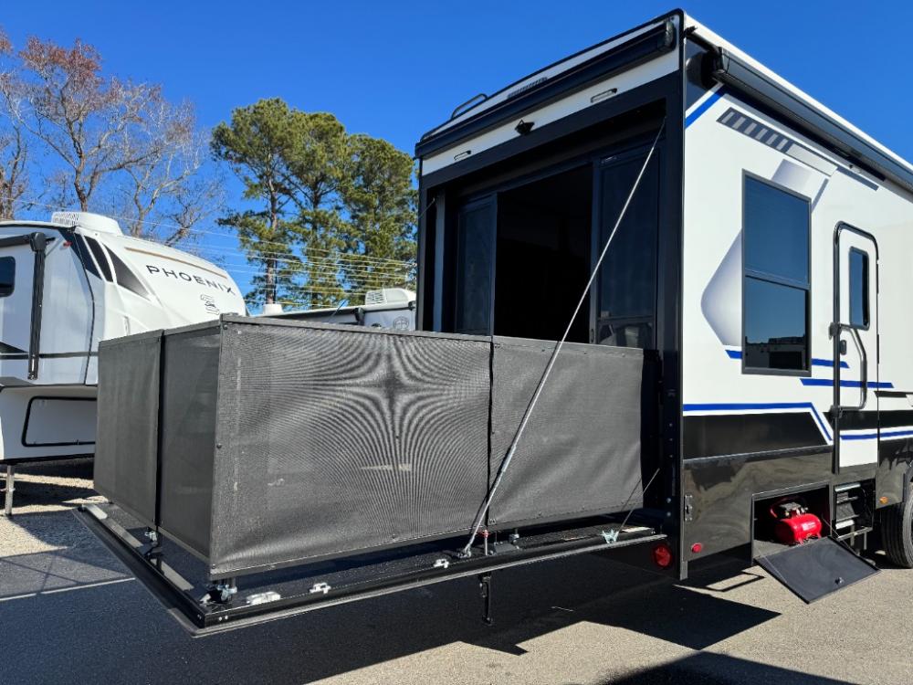 Rear patio deck system with awning and railing on Keystone Fuzion 432 toy hauler.
