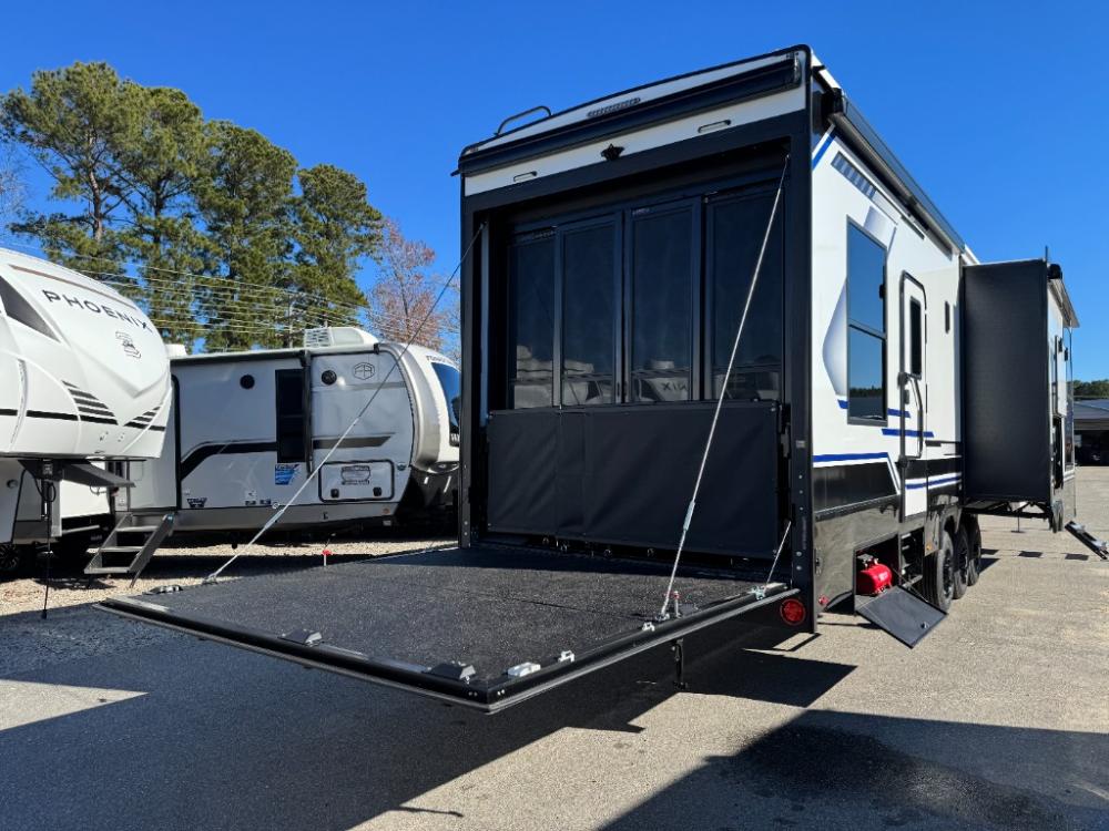 Rear patio deck system with awning and railing on Keystone Fuzion 432 toy hauler.