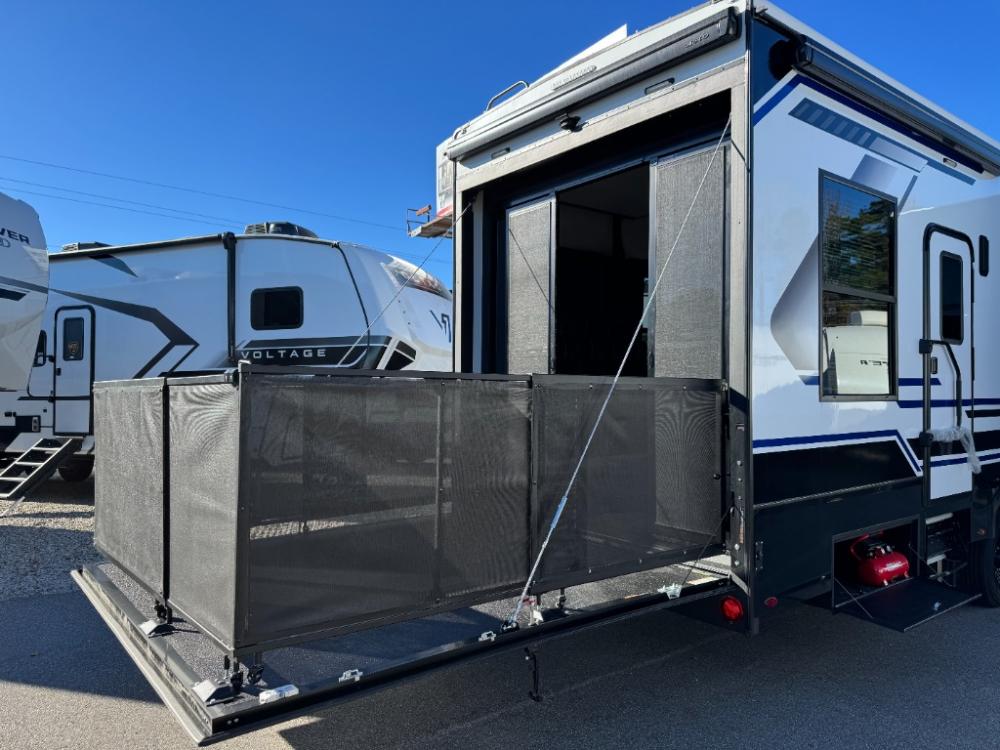 Exterior side view of 2026 Keystone Fuzion 373 toy hauler fifth wheel with dual awnings extended at Recreation USA