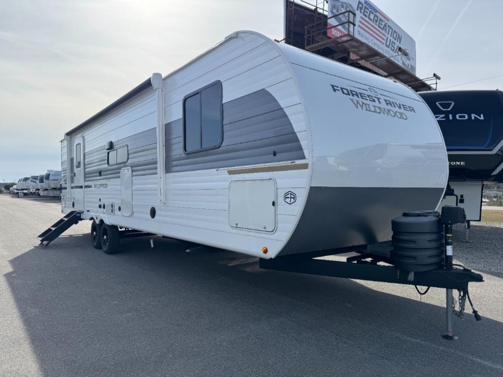 Exterior side view of New 2025 Forest River Wildwood 29BDB travel trailer at Recreation USA South Myrtle Beach and slide-out
