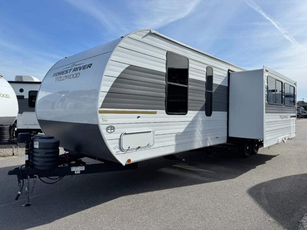 Exterior side view of New 2025 Forest River Wildwood 29BDB travel trailer at Recreation USA South Myrtle Beach and slide-out