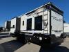 Exterior side view of 2026 Keystone Fuzion 373 toy hauler fifth wheel with dual awnings extended at Recreation USA