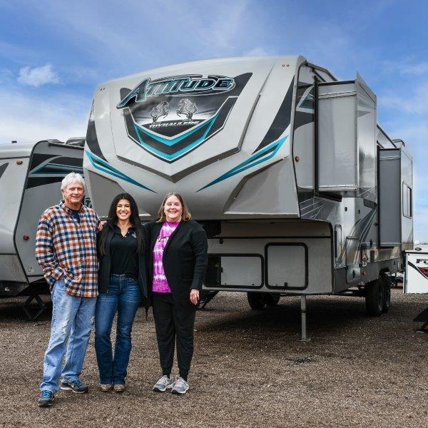 happy couple next to their new RV