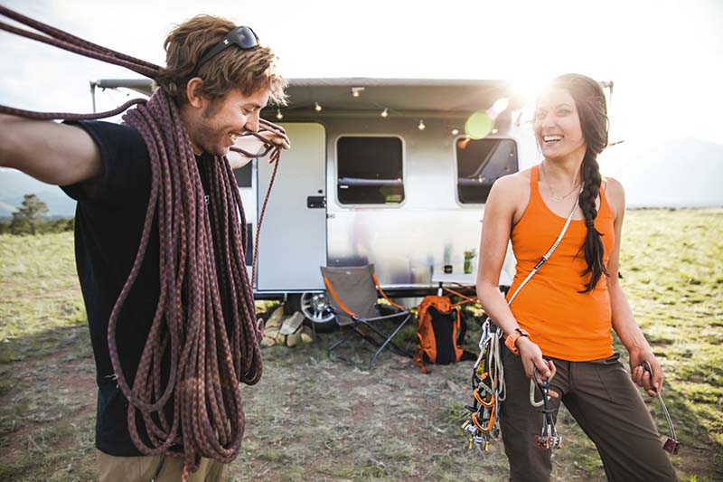 Couple camping with Airstream Sport Travel Trailer